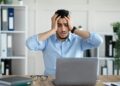 Desperate Arab businessman having too much work, making mistake, cannot meet deadline, suffering