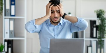 Desperate Arab businessman having too much work, making mistake, cannot meet deadline, suffering