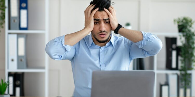 Desperate Arab businessman having too much work, making mistake, cannot meet deadline, suffering